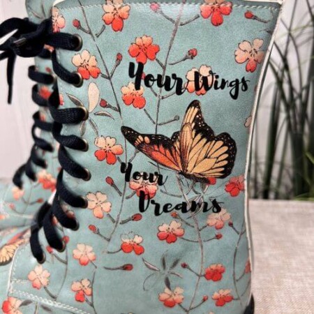 Turqoise blue combat boots with flowers and butterflies. Black sole and laces. Inside zip