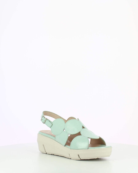 Mint Patent sling back wedge sandal with cutouts on a white base.