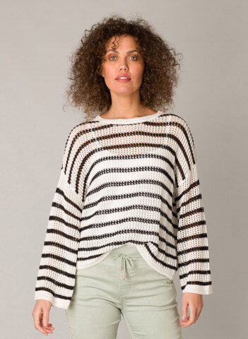Model in Yest Genivy black and white striped relaxed fit sweater.