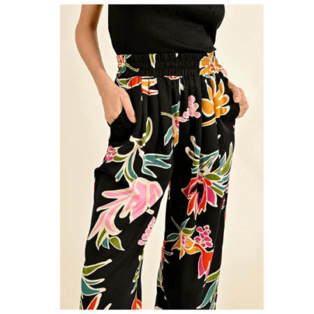 Molly Bracken's floral pants bring a burst of color to this woman's ensemble, with a striking black and pink pattern.