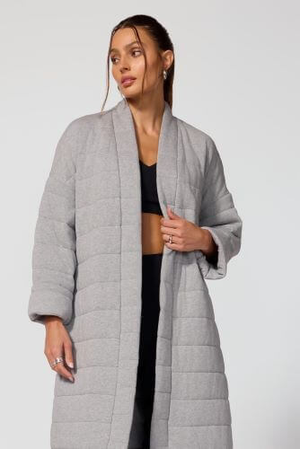 Model wearing the Immerse Studio Coat in grey.