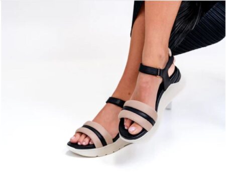 Model wearing the Alfie and Evie Batman sandal on a white background