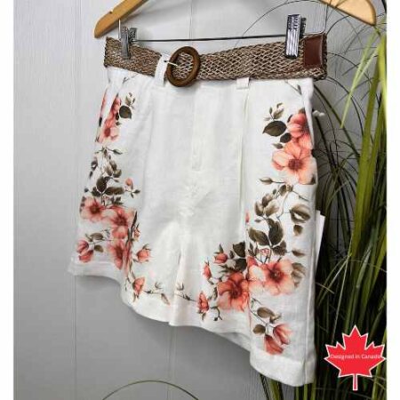 Point Zero Floral shorts with a woven brown belt on a light background.